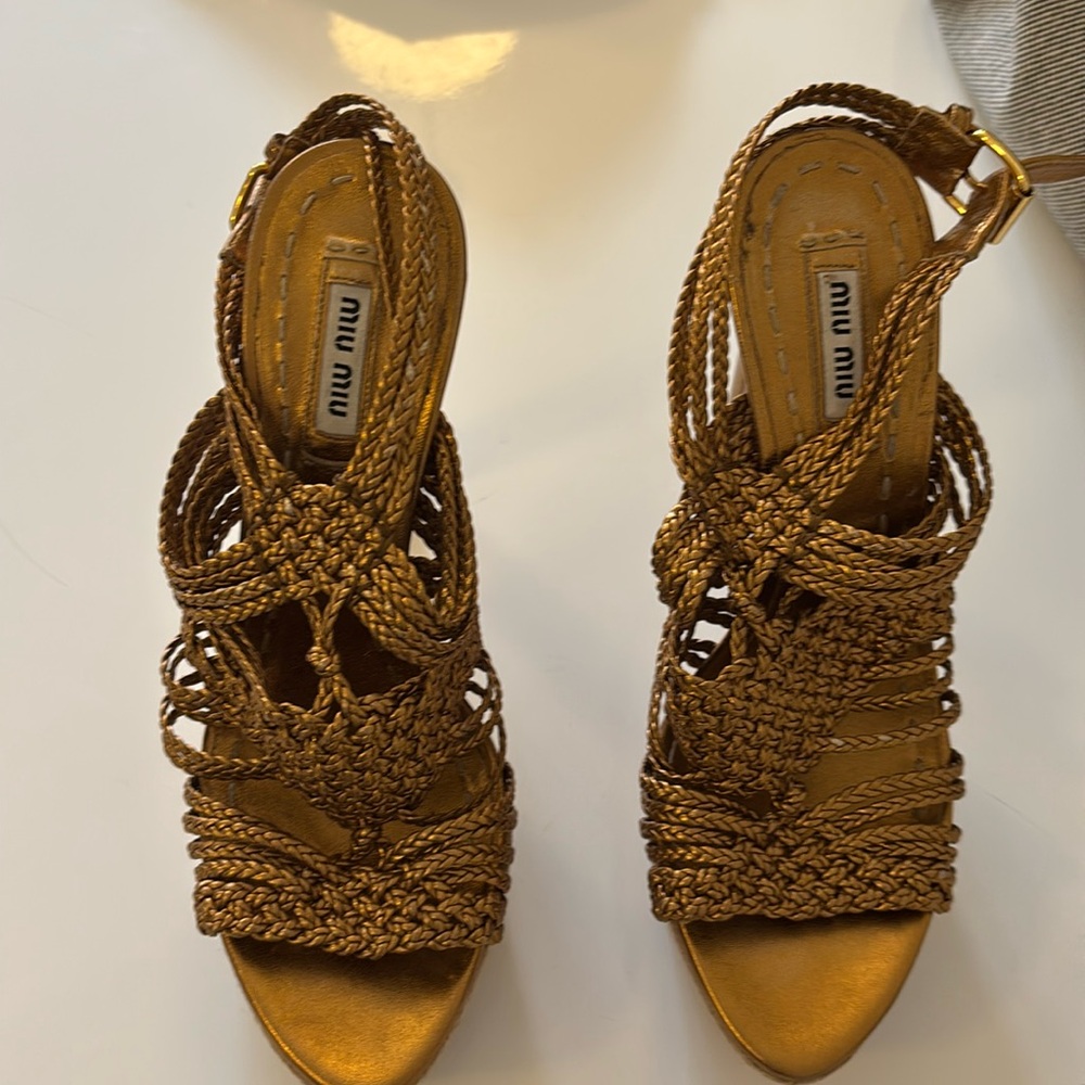 Miu Miu gold platform sandals.